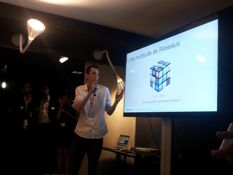 Guillaume Rouyer présente la multitude de réseaux sociaux devant la slide au Rubik’s Cube